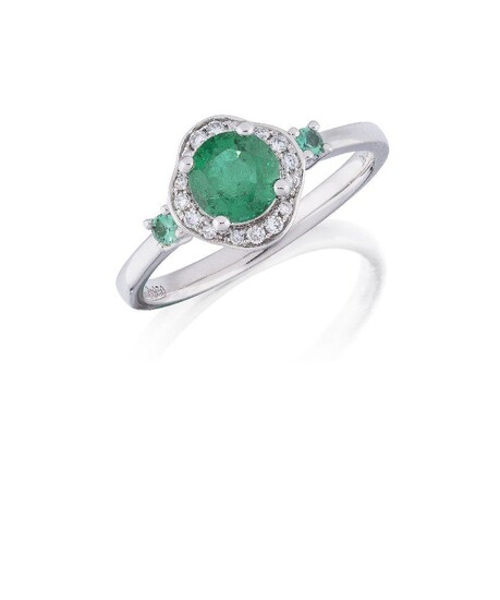 An emerald and diamond cluster ring, the circular emerald, weighing approximately 0.87 carats, to a brilliant-cut diamond lobed surround and circular emerald single stone shoulders, hoop signed David Jerome, ring size N Accompanied by report number...