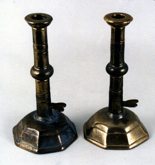 An unusual pair of Queen Anne brass ejector