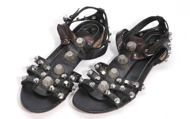 Balenciaga A pair of sandals of black leather with numerous silver toned...
