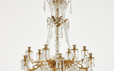 CHANDELIER, Oscarian, 10 candlesticks, 9 light sources, partly gilt, stem glass, hung with metered chains, spike prisms and leaf prisms.