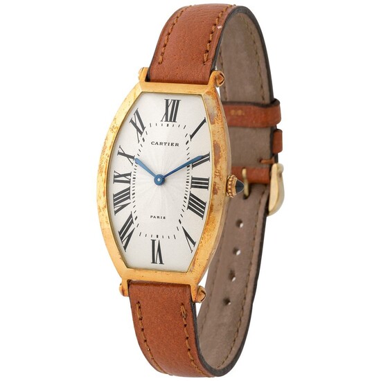 Cartier. Very Rare Tonneau-Shape Wristwatch in Yellow Gold, Reference 2435, With Silver Guillochè Roman Numbers Dial