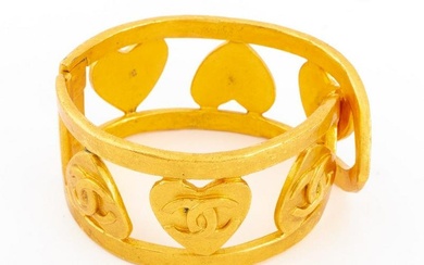 Chanel Runway gilt metal hinged cuff bracelet with pierced heart and signature double-C logo motif