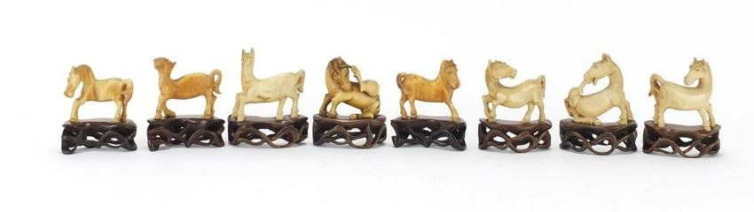 Eight Chinese carved ivory horses raised on carved