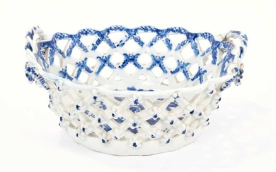 Lowestoft basket, of smaller oval form, the latticework pierced sides applied with florets at the intersections, printed in blue with the Pinecone pattern, the interior with an elaborate painted bo...