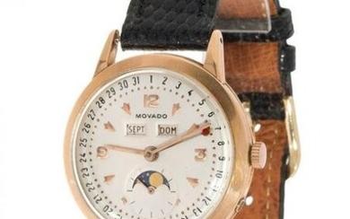 MOVADO watch in gold. White dial, Arabic and dotted numerals, calendar window for month and day.