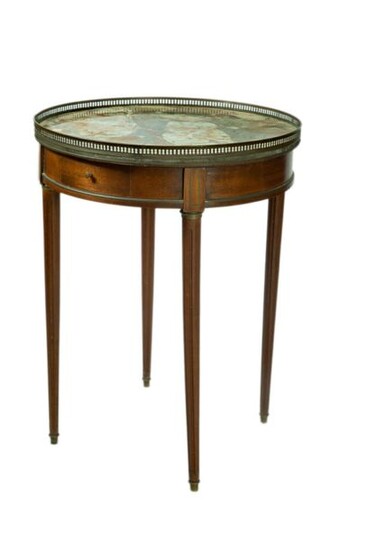 Mahogany and mahogany veneered bouillotte table, one drawer in the belt, fluted tapered legs (restored, to be refixed), brown veined marble top surrounded by a brass gallery. Louis XVI style. Height : 74 cm ; Diameter : 55 cm.