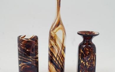 Michael Harris, a Mdina tortoiseshell studio glass vase, circa 1970, of square form with flared rim, 21.5cm high; with another Mdina vase of cylindrical form, 20cm high, each signed Medina to underside; together with a tall bottle vase probably by...