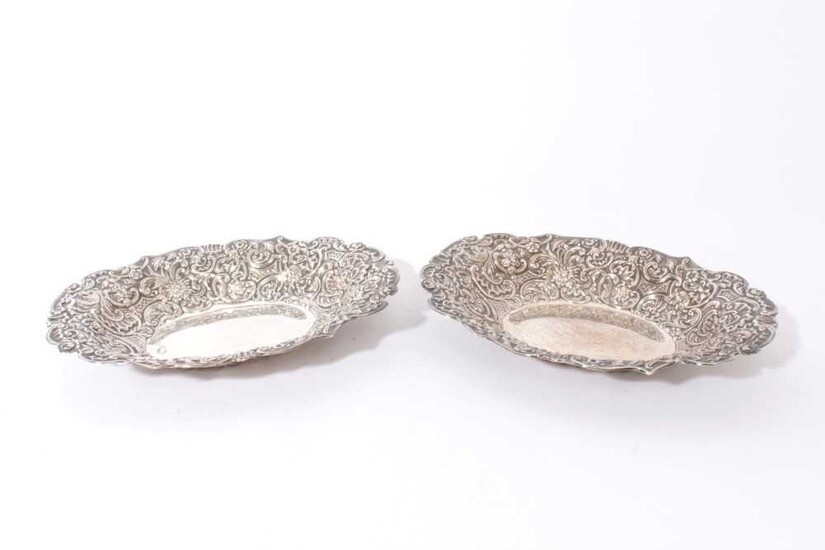 Pair Victorian Silver bread dishes of oval form with ornate embossed foliate, floral and scroll decoration (London 1895) Maker, William Comyns & Sons embossed oval dishes