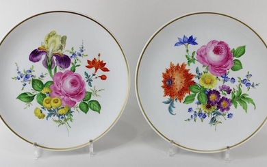 Pair of plates Meissen, 2nd half of the 20th century, decorated with gold and coloured ornaments, décor: flowers, among others red rose and forget-me-not, gold ribbon, diameter each ca. 25,7 cm, on the bottom blue sword marks, at the rim blue mark...