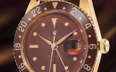 Rolex, Ref. 6542 A fine and rare yellow gold dual time wristwatch with sweep center seconds, date, brown lacquer dial and bakelite bezel