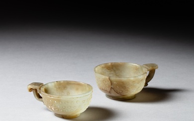 Two pale celadon jade archaistic handled cups, 17th - 18th...