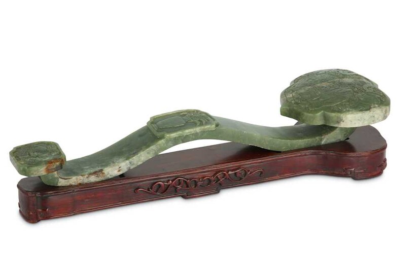 A Chinese celadon 'elephant wth a vase' jade ruyi sceptre.