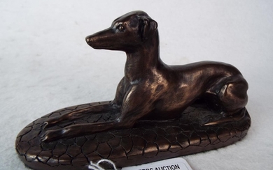 Bronze effect figure of a recumbent greyhound 6.5 inches long.