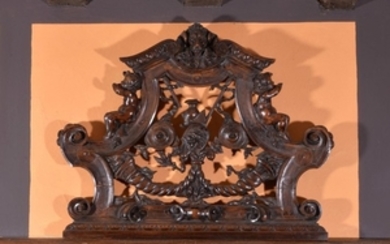 A carved walnut overdoor or wall panel, 19th century, in the Baroque taste