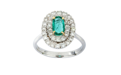 An emerald and diamond ring Set with an...