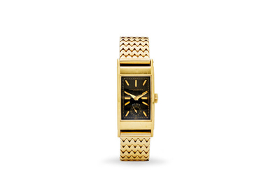 Patek Philippe. A fine 18K gold rectangular wristwatch with black dial and a 14K gold bracelet