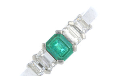A platinum emerald and diamond dress ring. View more details