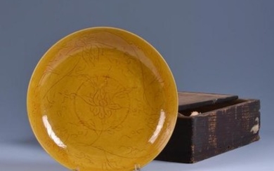 A rare Chinese yellow glazed dish with stylised floral designs