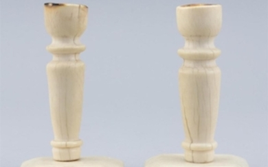 PAIR OF WHALEBONE CANDLESTICKS Turned socles and stems. Rectangular feet with beveled edges. Heights approx. 5".