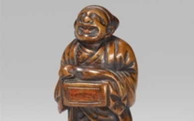 A boxwood netsuke of a street puppeteer. 19th century