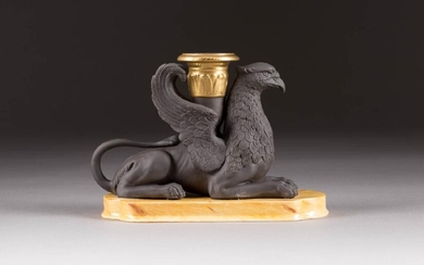 A PORCELAIN CANDLESTICK HOLDER IN THE FORM OF A GRIFFON