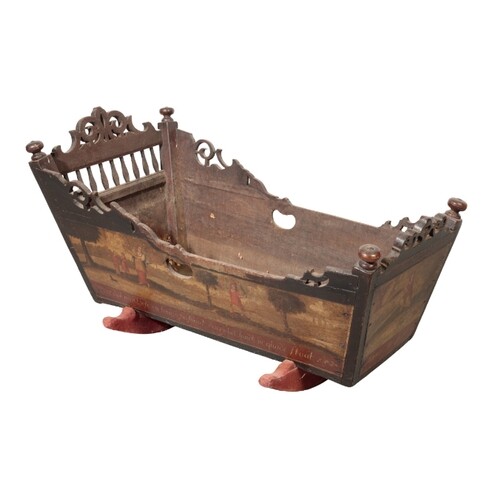 A 19TH CENTURY OAK AND POLYCHROME CRADLE, the sides painted ...