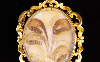 A 19th Century Pinchbeck & Hair Brooch. The oval opaline panel set with scrolled locks of blond and