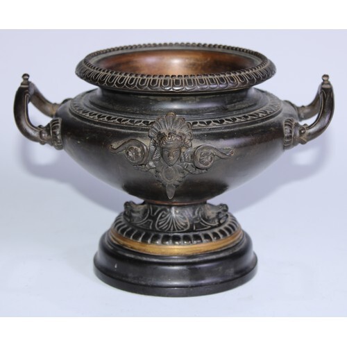 A 19th century brown patinated bronze pedestal urn, cast and...