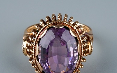 A 9ct gold and amethyst dress ring, the large oval mixed-cut...