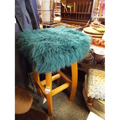 A Baa Stool beech stool with teal sheepskin loose cover