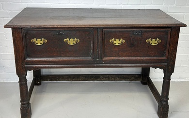 A CHARLES II OAK DRESSER WITH TWO DRAWERS RAISED...