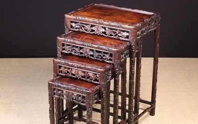 A Chinese Quartetto of Carved Hardwood Nesting Tables. Each having an inset rectangular panel top wi