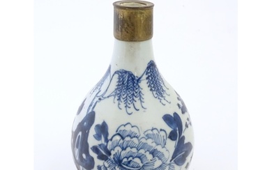 A Chinese blue and white bottle vase decorated with flowers ...