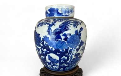 A Chinese blue and white ginger jar and lid on a pierced har...