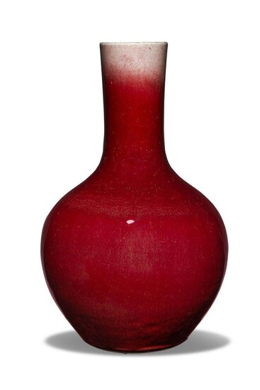 A Chinese porcelain monochrome langyao glazed vase, tianqiuping, 19th century, covered in a rich deep red glaze thinning to milky-white around the rim, 37cm high