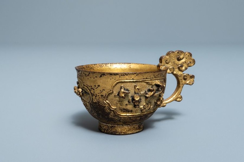A Chinese relief decorated gilt bronze cup, Ming...