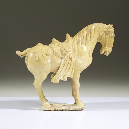 A Chinese straw-glazed pottery horse, in Tang dynasty