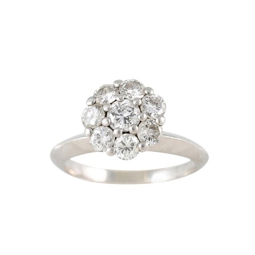 A DIAMOND CLUSTER RING, mounted in white gold. Estimated: we...
