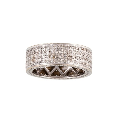 A DIAMOND ETERNITY BAND, set with four rows of brilliant cut...