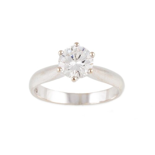 A DIAMOND SOLITAIRE RING, the brilliant cut diamonds mounted...