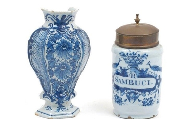 A Dutch Delft apothecary jar, with brass top with urn finial, inscribed 'R Sambuci' within cartouche with a basket of fruit, peacocks and cherub mask, damage to rim, marked 'P' to underside, total height 22.5cm, together with a Delft hexagonal...