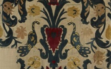 A European silk and velvet textile fragment, 19th century, with crimson vases of flowers, the central cartouche panel flanked by exotic birds, mounted on a modern cotton ground, 106 x 54cm overall