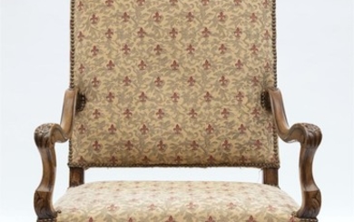 A FRENCH LOUIS XV STYLE WALNUT ARMCHAIR WITH FLEUR DE LIS UPHOLSTERY. SEAT HEIGHT 44CM