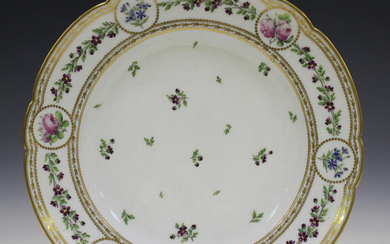 A French porcelain circular dish, late 19th century, painted to the centre with scattered floral spr