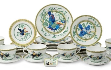 A Hermes Porcelaine 'Toucans' pattern dinnerware set, c.1980s, of cream ground with bright green and yellow borders and decorated with designs of toucans and leafy branches, each with green printed factory mark to underside, comprising: six dinner...