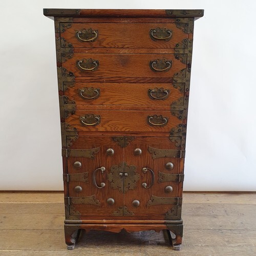 A Korean chest, having three drawers and two cupboard doors,...