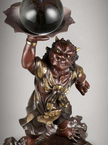 A LARGE BRONZE FIGURE OF AN ONI WITH CRYSTAL BALL