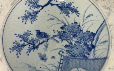 A LARGE JAPANESE BLUE AND WHITE PLATE DECORATED WITH...