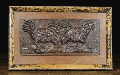 A Late 17th Century Carved Oak Panel depicting two fighting cocks with a tree to the centre distance
