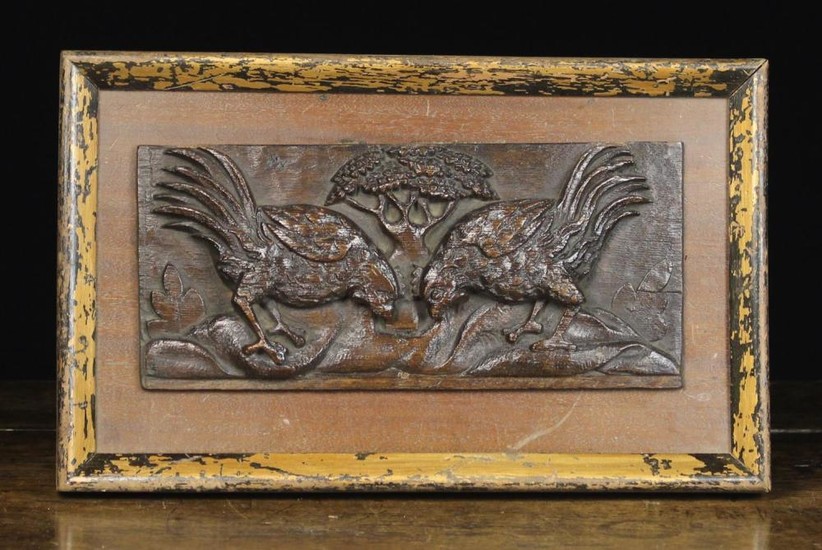 A Late 17th Century Carved Oak Panel depicting two fighting cocks with a tree to the centre distance